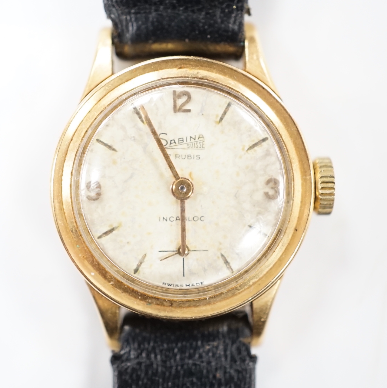 A lady's Swiss Sabina 18k manual wind wrist watch, on a leather strap.